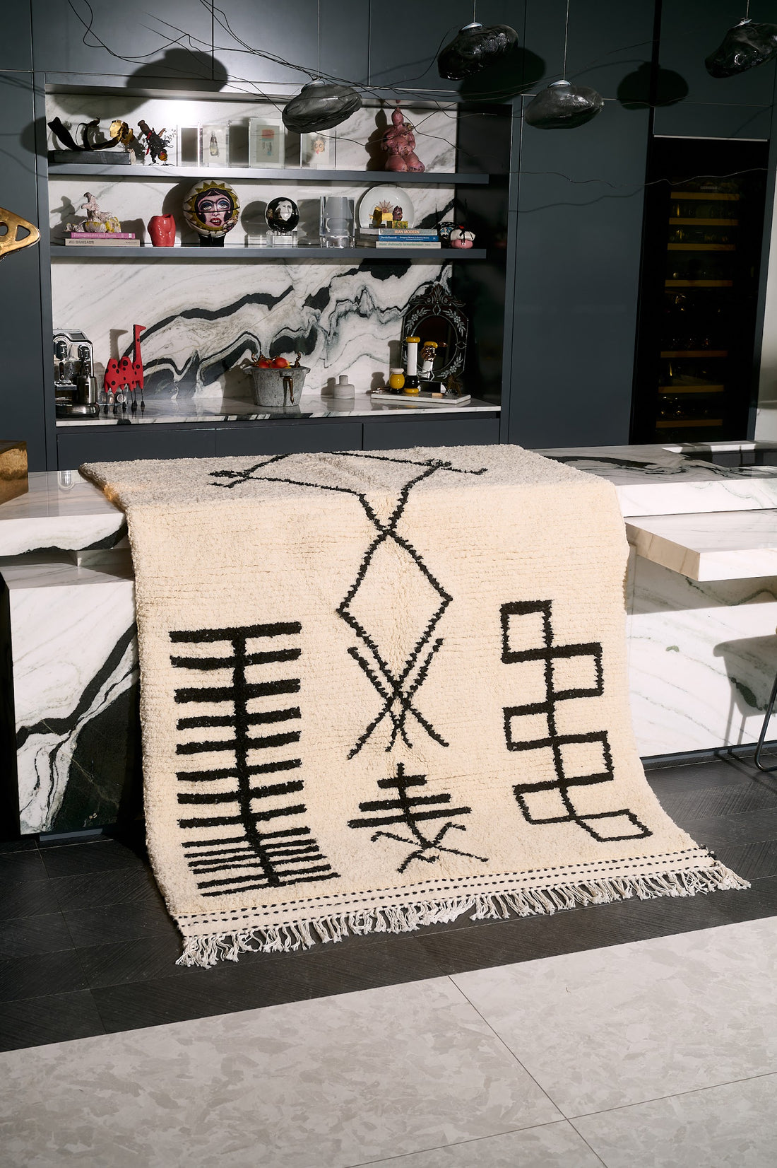 Beige rug with black abstract designs on a tiled floor