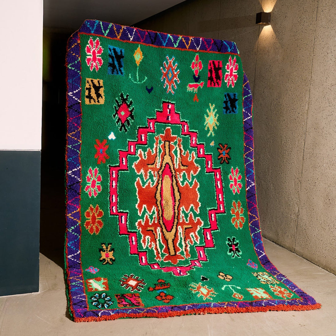 Colorful patterned rug on a plain floor with a neutral wall background