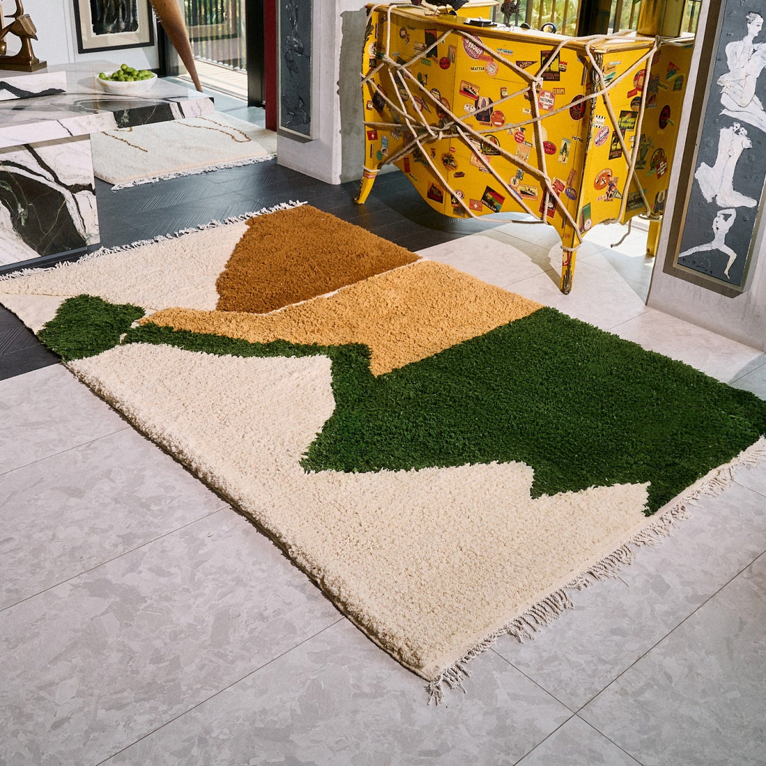 Colorful abstract rug on a gray floor with a modern interior setting.
